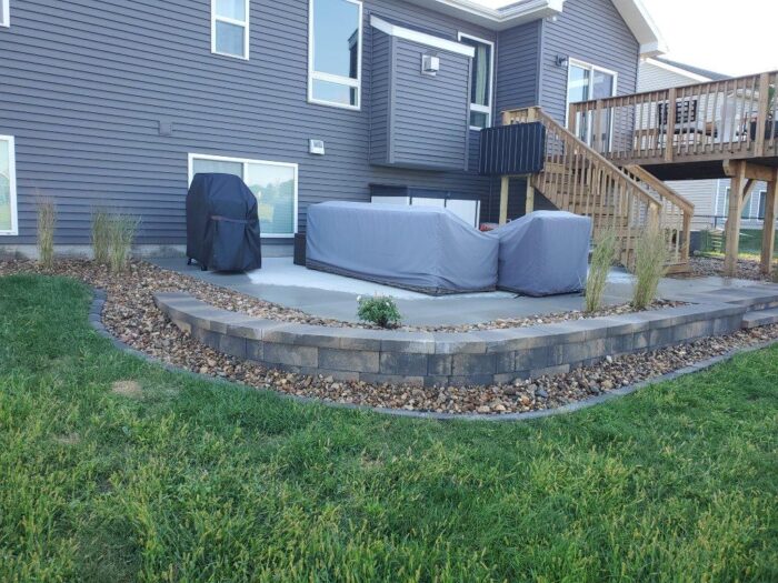 Retaining Wall with Rock Bed after photo of retaining wall and rock bed landscaping project