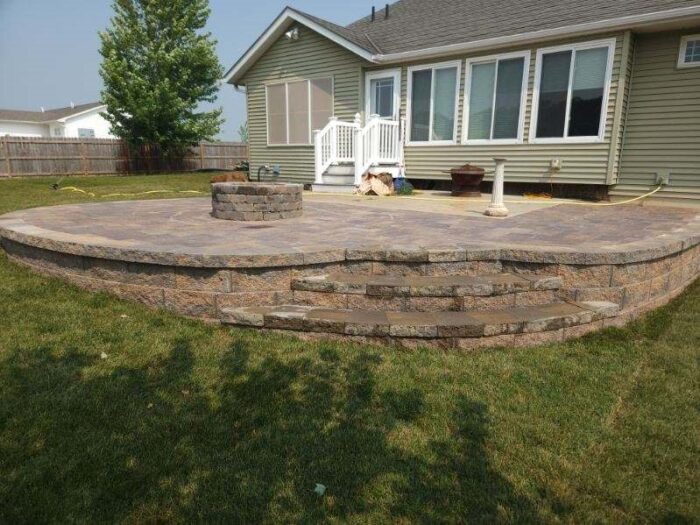Raised paver patio with fire pit Raised patio with fire pit, Waverly, Iowa Landscaping